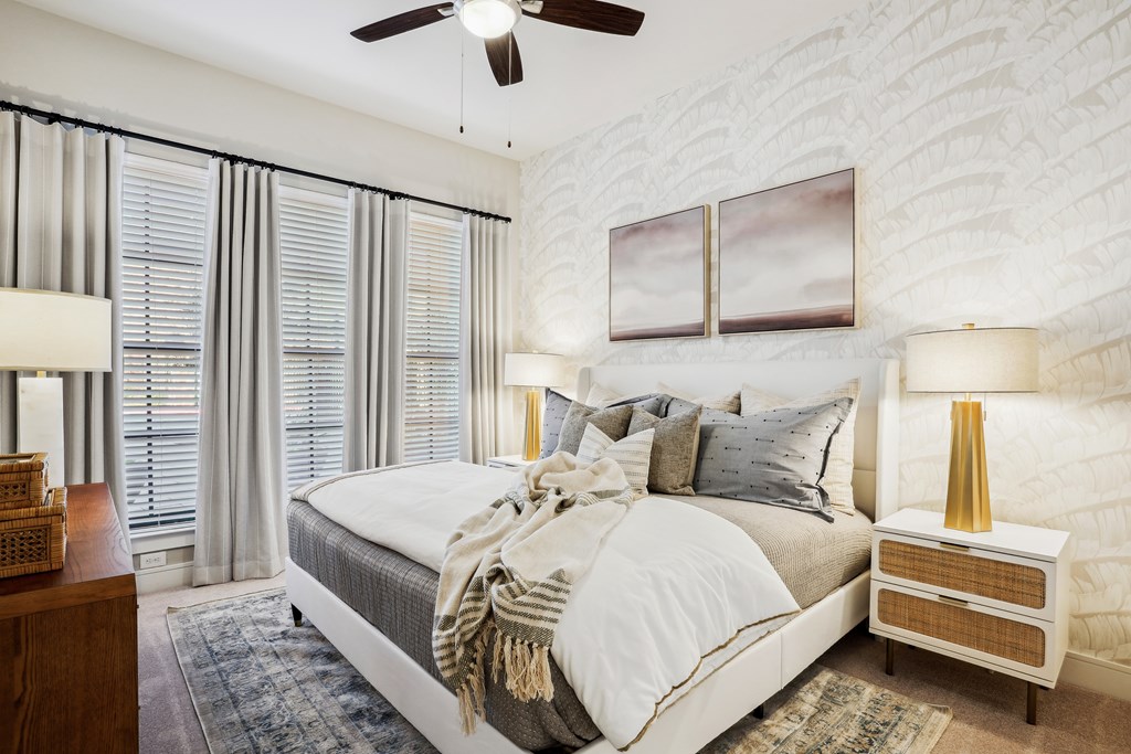 a bedroom with a bed and a ceiling fan