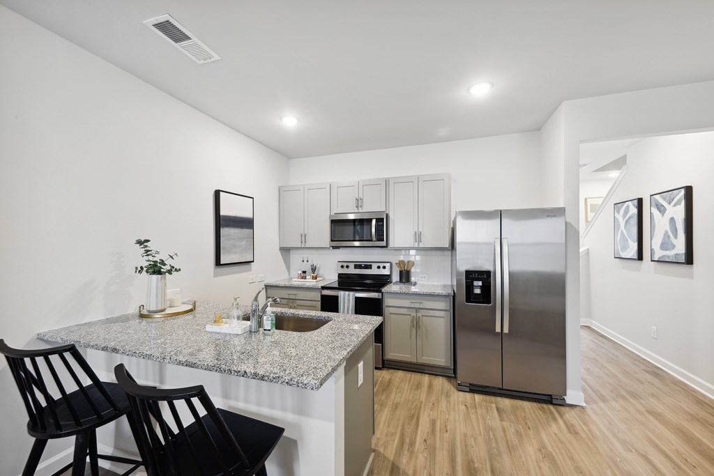 a kitchen with stainless steel appliances and a granite counter top