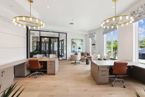 a large office space with desks and chairs and large windows