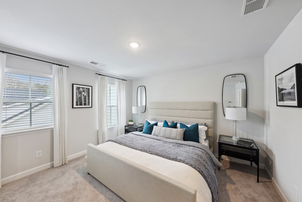 a bedroom with a bed and a large window