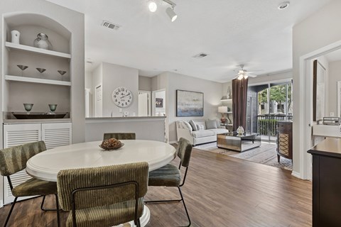 A dining room with a round table and chairs.