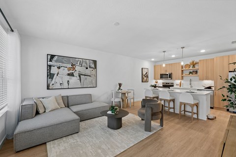 A modern living room with a grey sofa and a coffee table.