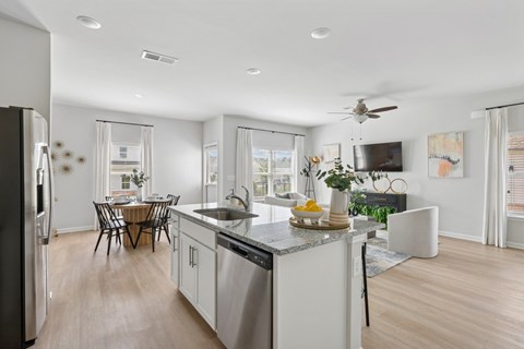 A modern kitchen with a dining table and chairs.
