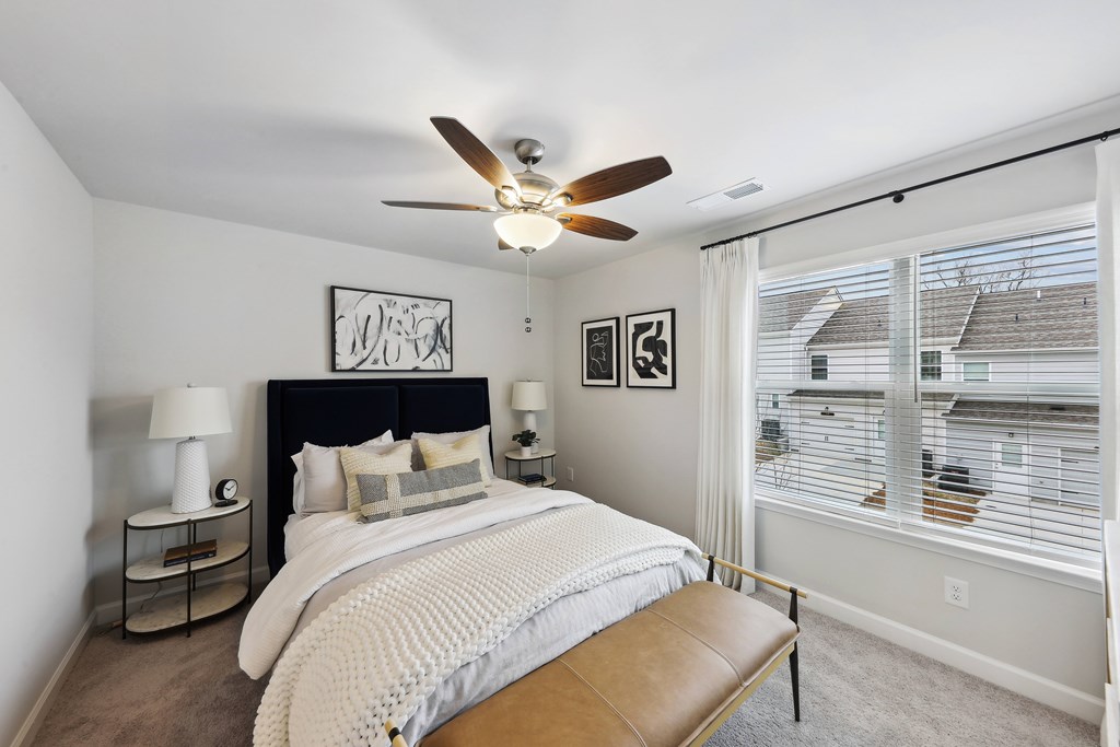 a bedroom with a bed and a ceiling fan