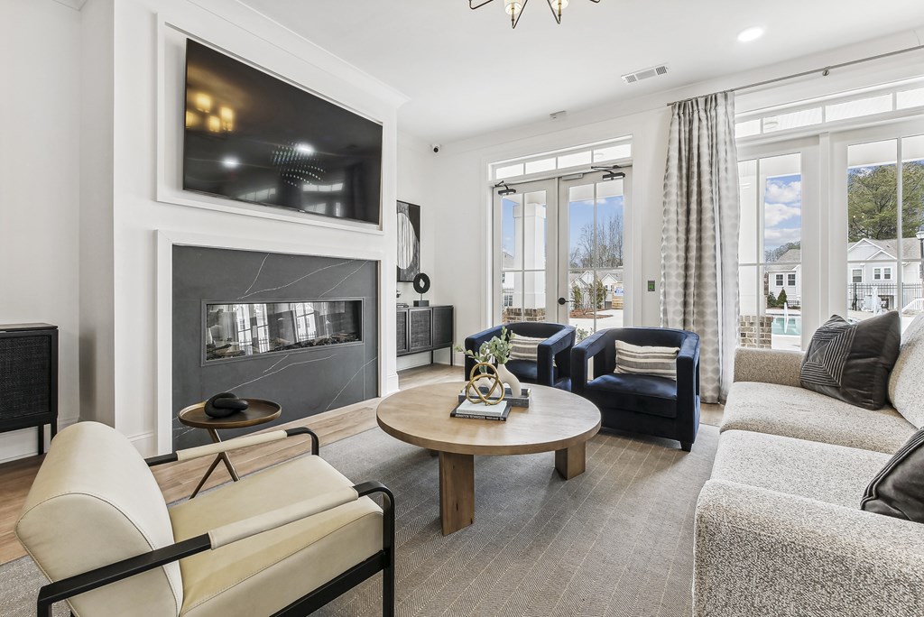 a living room with couches and chairs and a fireplace