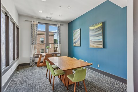 A dining room with a table and chairs.