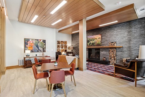 A modern dining room with a wooden table and chairs.