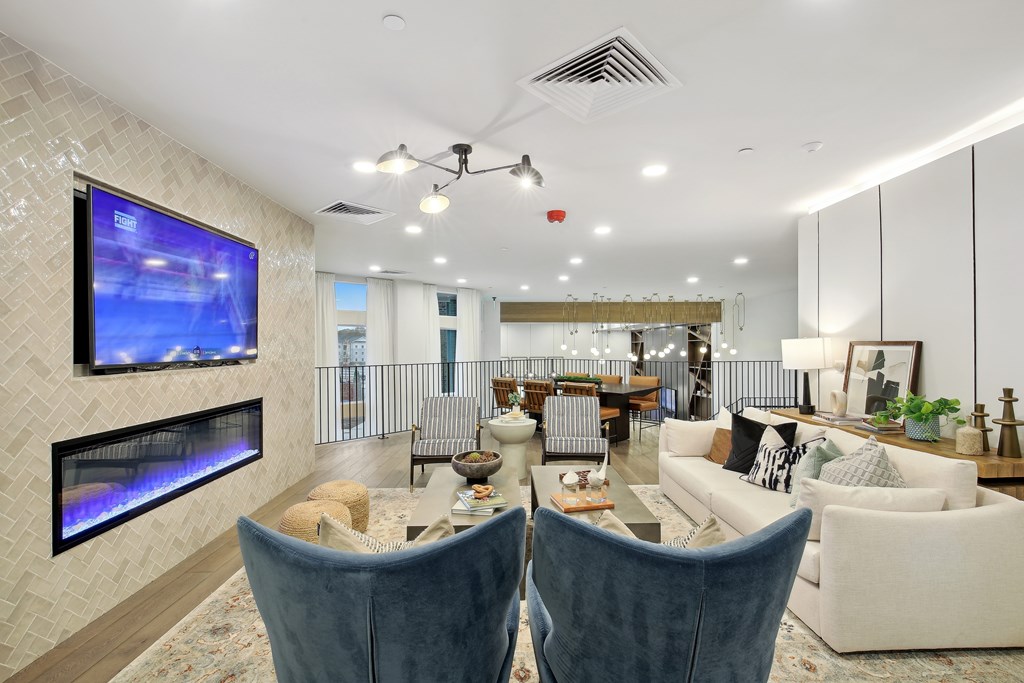 a living room with couches and chairs and a fireplace