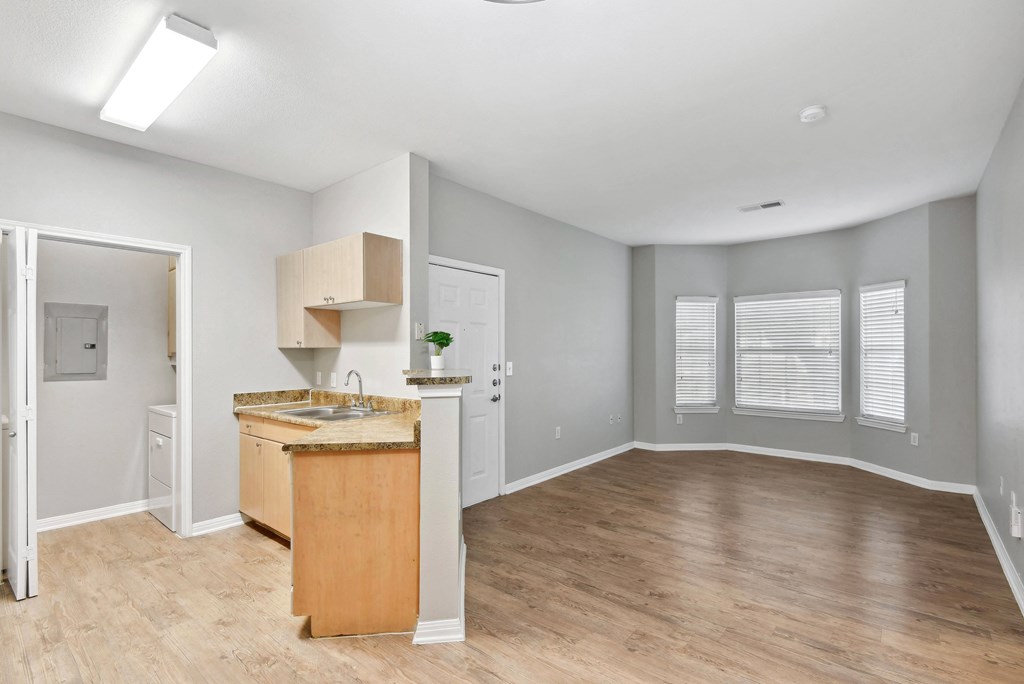 kitchen and living room with large windows and wood style flooring