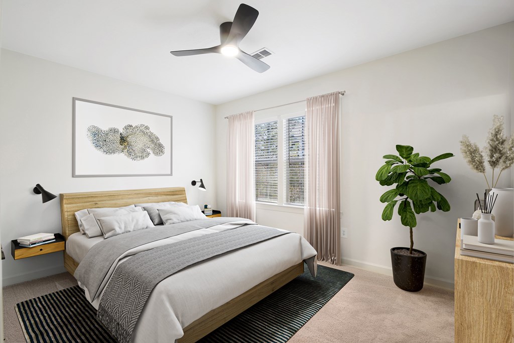 a bedroom with a bed and a ceiling fan
