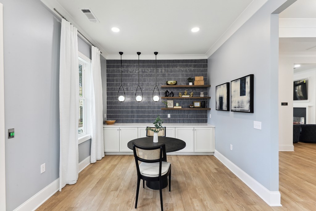 a dining room with a black table and two chairs