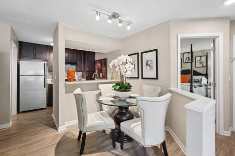 A modern kitchen with a dining table and chairs.