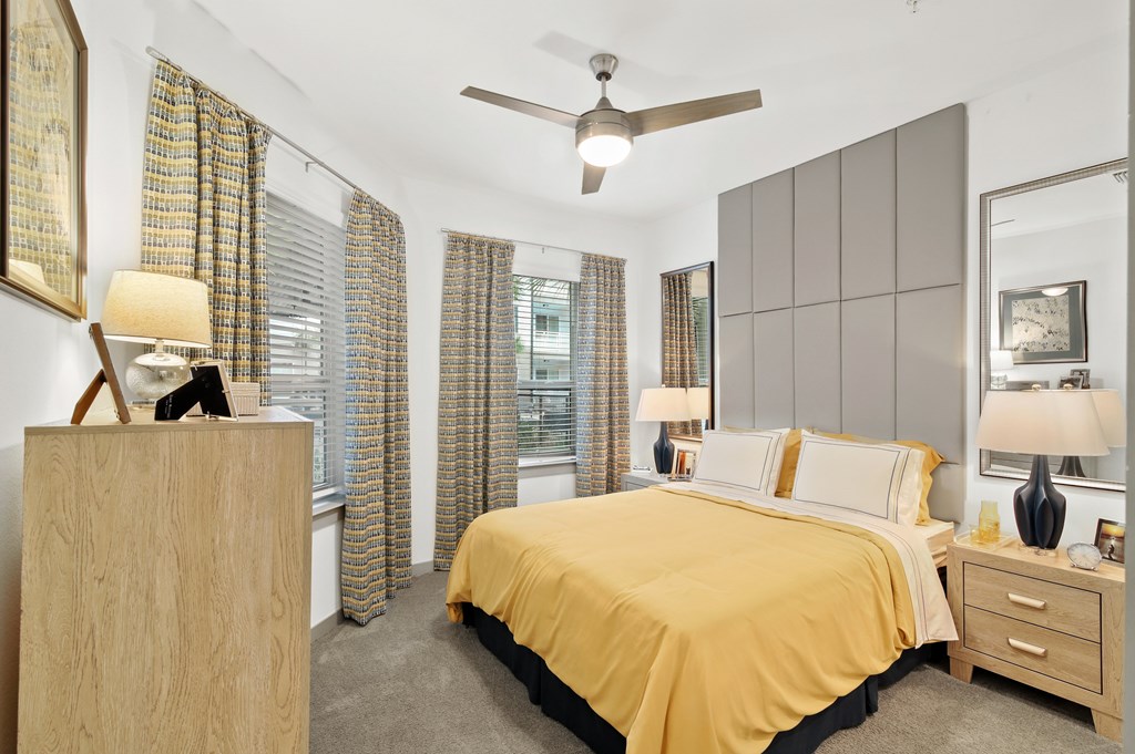 a bedroom with a bed and a ceiling fan