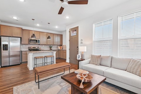 A modern kitchen with wooden cabinets and a white island.