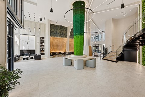 A large green pillar is the centerpiece of a spacious, modern interior.