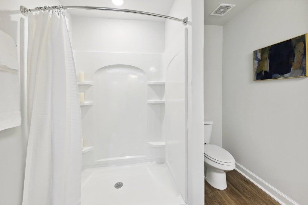 a bathroom with a shower and a toilet