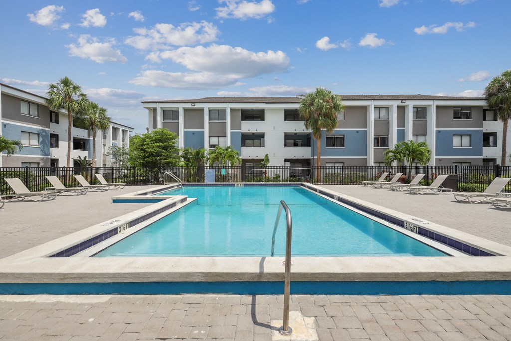 a swimming pool in front of an apartment building