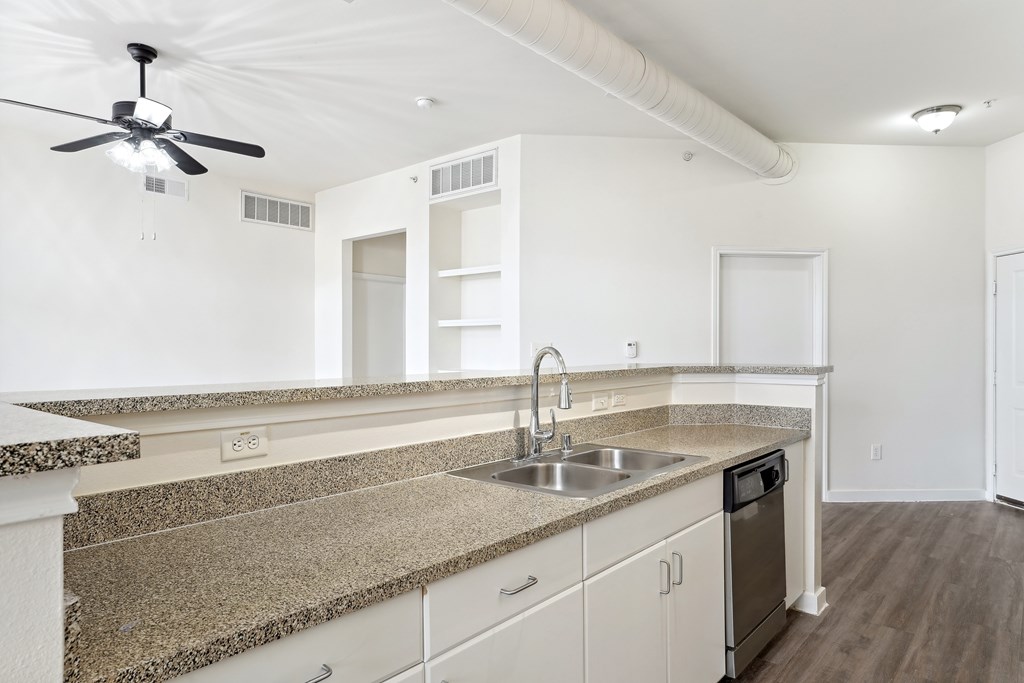 Traditional Kitchen with White Cabinetry, Granite Countertops, Hardwood Style Flooring, and Stainless Steel Appliances