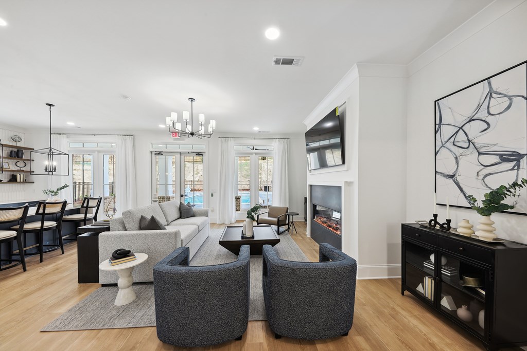 a living room with couches and chairs and a television