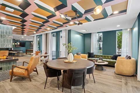 A modern dining room with a round table and chairs.