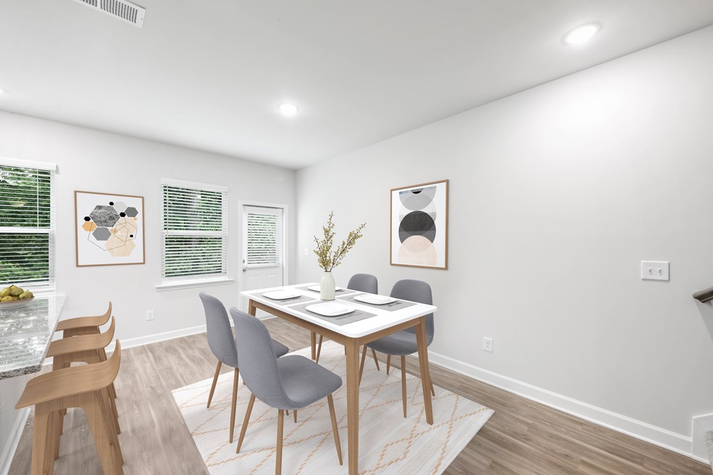 a dining room with a table and chairs