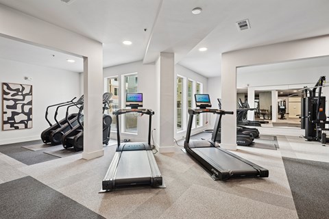 A spacious gym with treadmills and other exercise equipment.