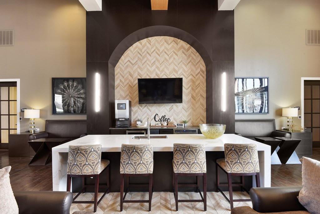 a kitchen with a marble counter top and bar stools