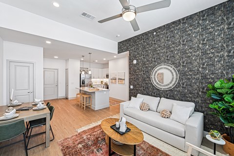 A living room with a grey couch and a wooden coffee table.