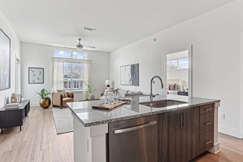 A modern kitchen with a large island and stainless steel appliances.