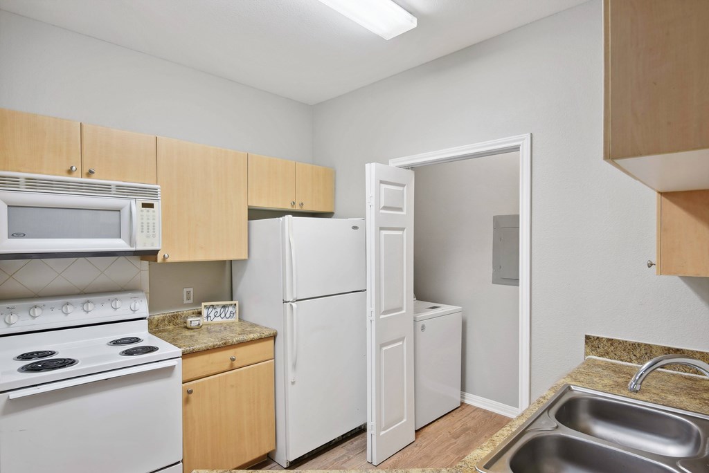 kitchen with appliances and hardwood like flooring