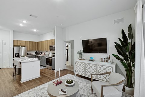 A modern living room with a white sofa and a coffee table.