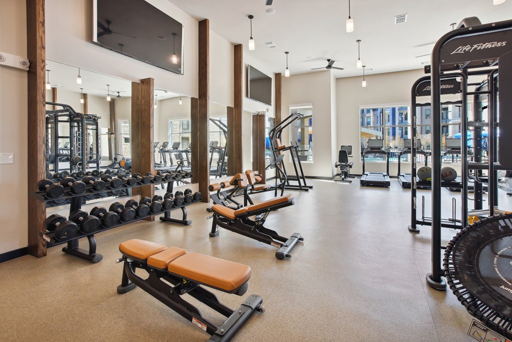a fitness center with weights and other exercise equipment in a building