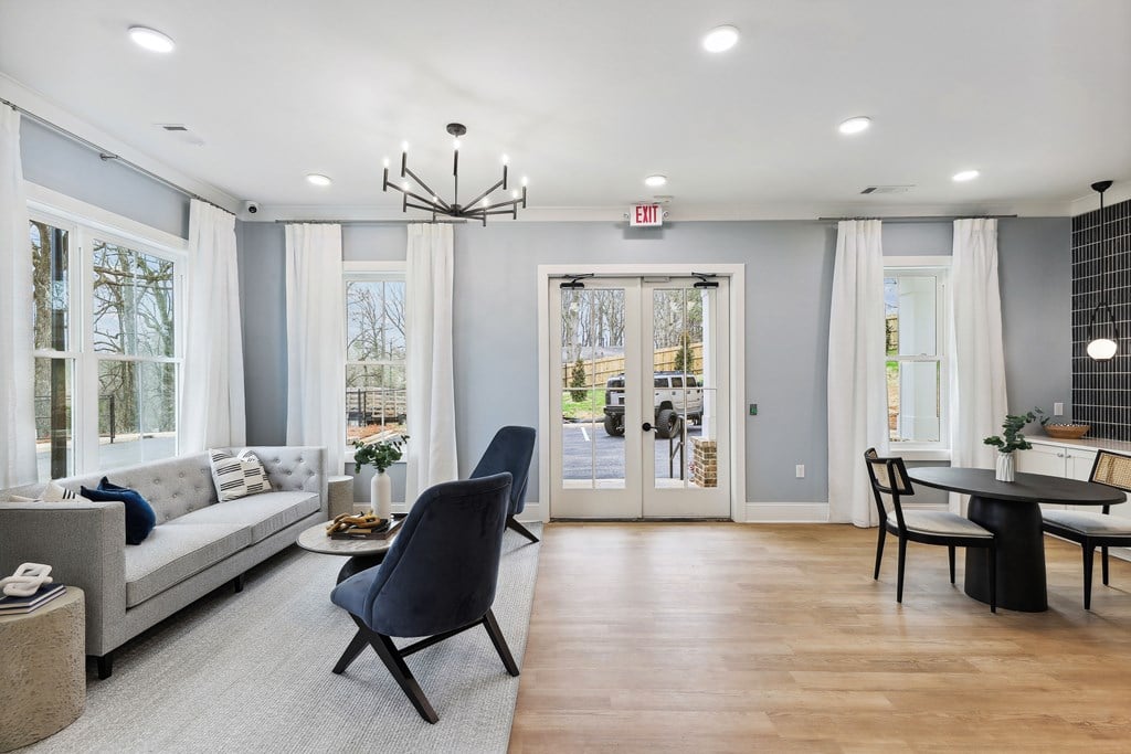 a living room with a couch and a table and chairs