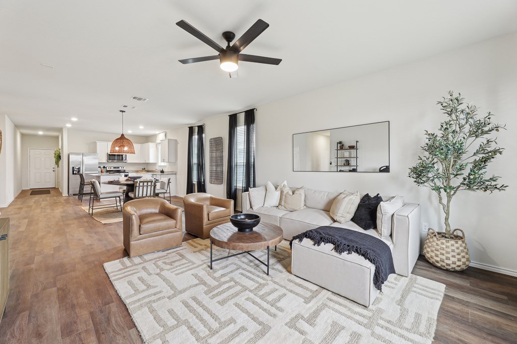 A living room with a white couch and a rug.
