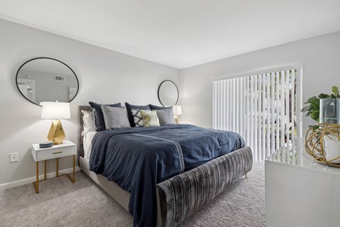 a bedroom with a large bed and a window