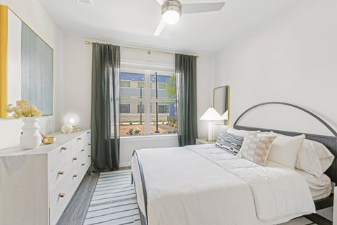 a bedroom with a large bed and a window