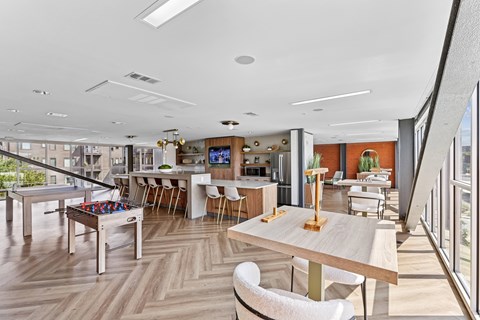 A modern dining area with a long table and chairs.