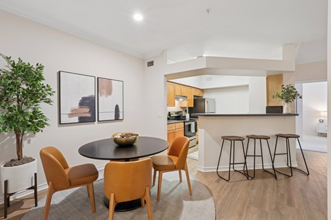 A modern dining room with a round table and chairs.