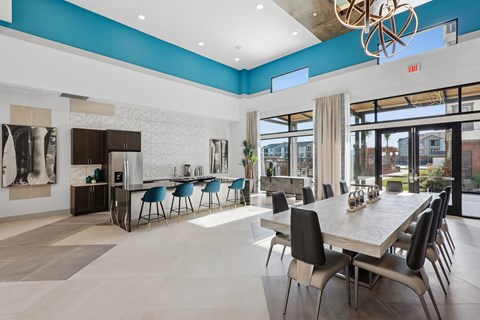 A modern dining room with a long table and chairs.