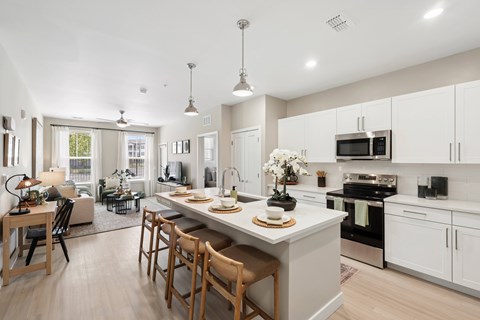 A modern kitchen with a dining table and chairs.