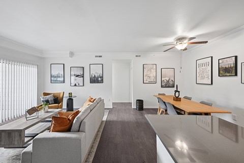 A living room with a grey couch and a wooden table.