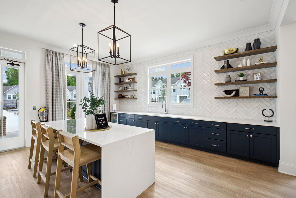 a kitchen with a white counter top and blue cabinets