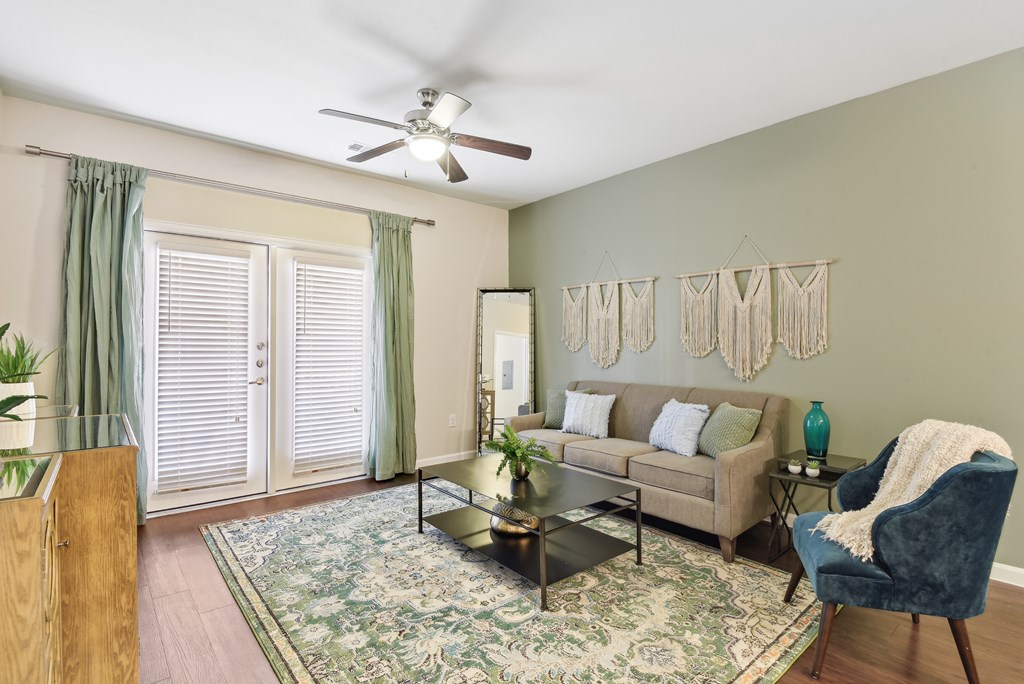 a living room with a couch and a ceiling fan