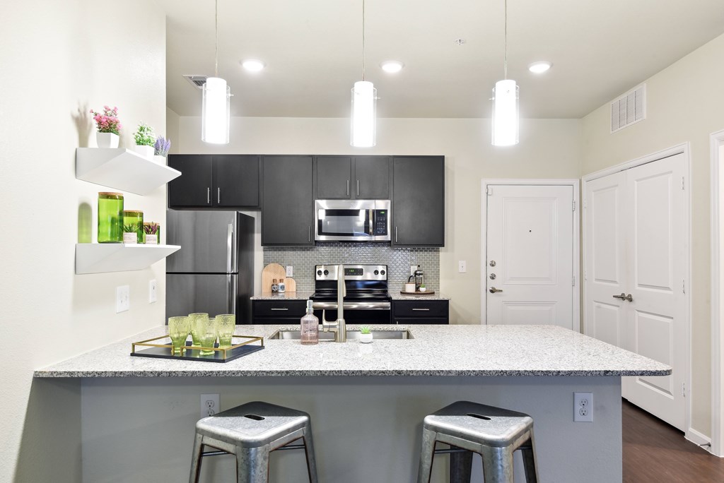 a kitchen with a counter top and stools
