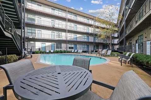 A pool with chairs and a table
