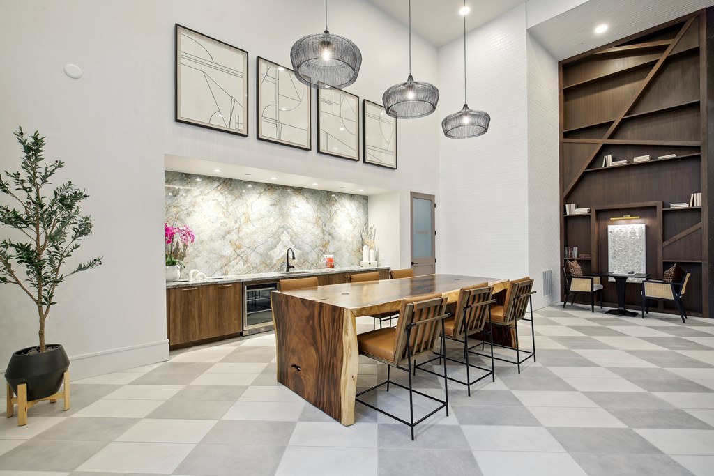 a large dining room with a long wooden table and chairs