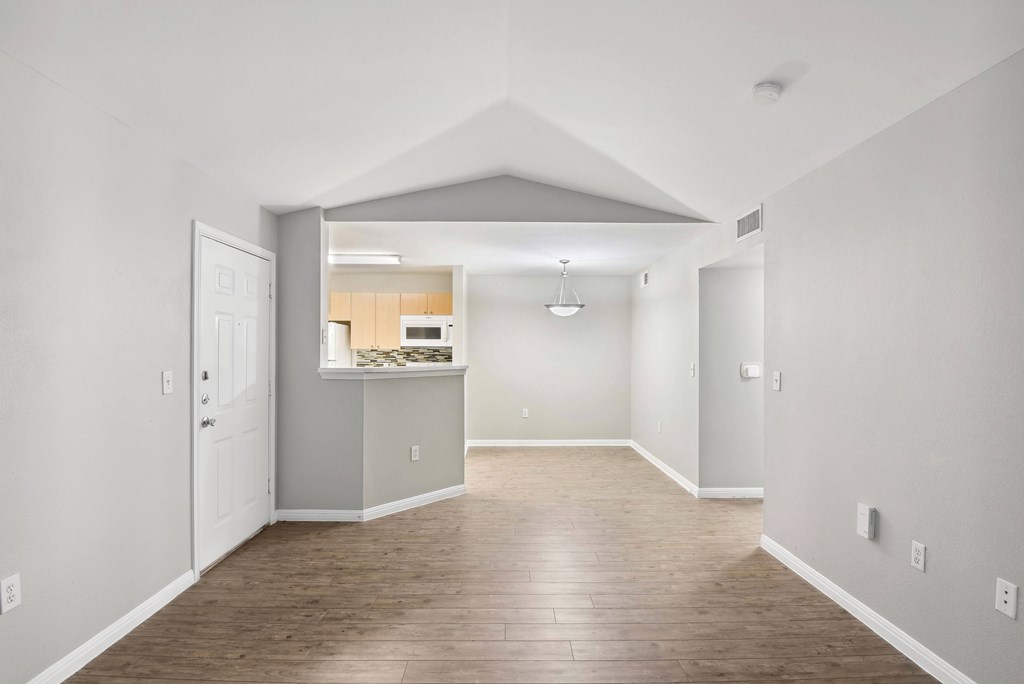 living room with vaulted ceiling and wood looking flooring