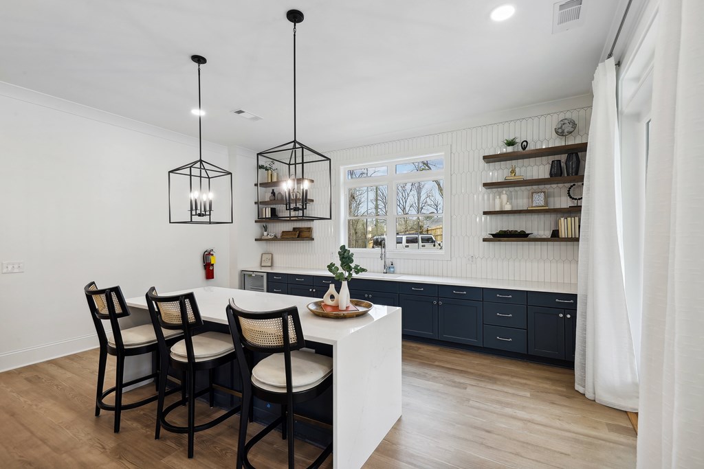 a kitchen with a white counter top and blue cabinets