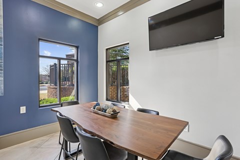 A dining room with a wooden table and chairs.