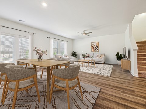 A dining room with a table and chairs.